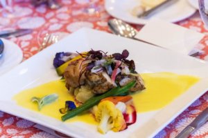 The second course was pan seared North Atlantic salmon with sugar snap peas, haricots verts, rainbow carrots, and fingerling potatoes.(Photo by Carrie Bradburn/CAPEHART)