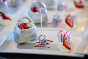 Dessert was a trio of sweets - a silver white chocolate purse, a dark chocolate lollipop, and a strawberry petit four.(Photo by Carrie Bradburn/CAPEHART)