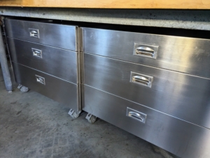 Industrial rolling restaurant storage units made in stainless steel are easy to keep clean. The Flower Room is also an outdoor kitchen which we often use for cooking when I entertain. These drawers store utensils and other tools, so the counters can be used for food preparation.