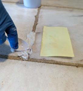 Next, using a plastic disposable spoon, I packed and smoothed the grout into the joint. One could use a tile float, but for small areas, these spoons do a great job - so flexible and light.