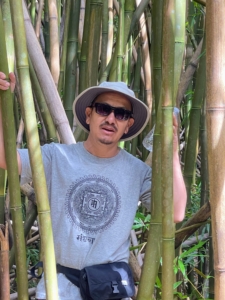 Here is Chhiring surrounded by growing bamboo. Bamboo is not native to the Hawaiian islands. It was brought to Hawaii by Polynesian voyagers who used the versatile material to make canoes and fishing poles. Bamboo grows very fast and has become invasive in some areas.
