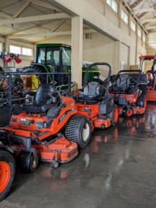 We have a fleet of Kubota mowers. They are used almost daily during the warmer months. Here, they are parked in a designated spot, where they can easily be driven out when needed.