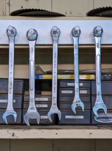 All the smaller tools, such as these large combination wrenches are also organized and hung over the workbench.