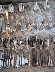 Like spoons are stacked with the stems slightly spread, so they can be counted without being touched.
