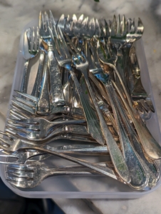 When it is time to clean, batches of flatware are removed from the drawer and brought over to the sink. With so many to do, it is wise to use a production line process to get them done quickly and efficiently.