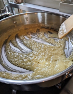 The mixture is stirred constantly until it becomes the color of dark peanut butter, about five-minutes.