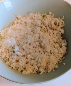 Once the rice is done, it is fluffed and spooned into a bowl.