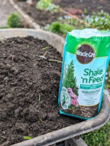 Remember what I always say, "if you eat, so should your plants." We're using Miracle-Gro Shake 'N Feed Flowering Trees and Shrubs Plant Food. It contains natural ingredients to feed microbes in the soil and provide continuous release feeding to maintain deep, lush green foliage.