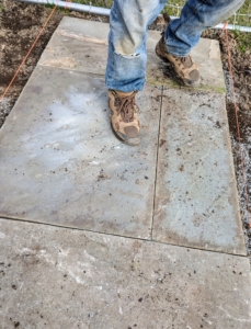 After the stone is in place, Pete steps on it and tests its sturdiness - no teetering allowed.