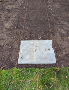 The first paver is positioned - this one next to the grass.