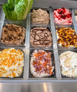 Some of the cream cheese spreads include cinnamon raisin, mango, walnut raisin, nutella, lox with capers and bacon, strawberry, mango and bacon, and vegetable.
