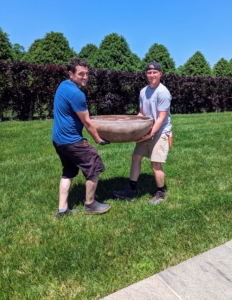 Here are Ryan and Josh carrying one of the very heavy round bowl planters poolside.