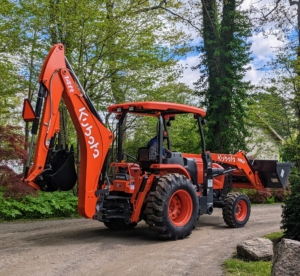 This is the Kubota M62 Tractor Loader Backhoe. This is essential for digging holes and planting large trees. It has a 63 horsepower engine, a front loader with a lift capacity of 3,960 pounds, and a powerful backhoe with 169.8 inch digging depth.