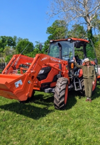 I am out and about around my farm several times a day - checking the gardens, pruning trees and shrubs, weeding, watering, and working with our big agricultural equipment. Here I am with my Kubota M4-071 tractor in one of my horse pastures.