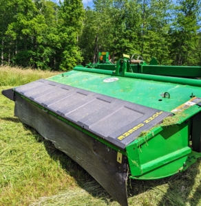 This is our mower-conditioner. Mower-conditioners are a staple of large-scale haymaking. It cuts, crimps, and crushes the hay to promote faster and more even drying. It is the first step in the hay baling process.