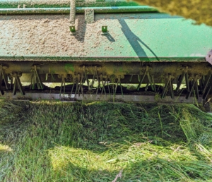 The discs and blades are located behind the protective shield of the mower-conditioner.
