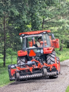 The tractors are also essential for maintaining the four miles of carriage road around my farm. The Land Pride PR1690 Power Rake is secured to the back of our tractor in order to rake and grade the carriage roads, but it is also capable of windrowing soil, rocks, and debris in a field.