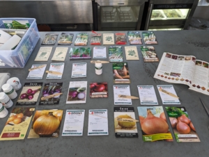 Our seed packets are kept in plastic envelopes, and plastic bins – all are labeled and filed for easy reference and stored in a greenhouse refrigerator. Then, when it is time to seed our trays, we know they are well organized and in good condition. Here are many of our seeds for onions and leeks. We get our seeds from our favorite companies and wherever I find them during my travels.