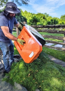 When it's time, Adan simply lifts the polymer grass bag out of the mower and empties it onto a nearby tarp, so it is easy to load onto the dump truck.