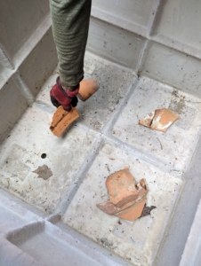 Shards are placed in the bottom of the container. This is so soil does not fall through the holes or block any drainage.