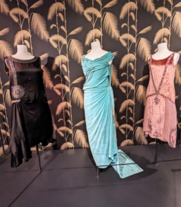 The blue evening gown belonged to Anna Gould, which she wore in her 50s. The style elongated her silhouette with its dangling passementerie and train. This gown is one of five recently acquired by the Lyndhurst and inspired this exhibit.