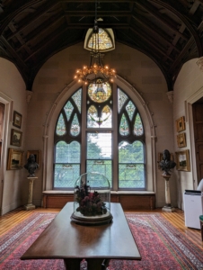 The main house has a soaring two-floor Art Gallery, which was once also used as a library and billiards room. Today, the room is filled with 19th century academic paintings along with Tiffany glass windows and other period furnishings designed by Davis.