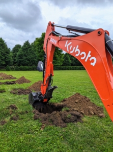 And then the digging begins. Chhiring maneuvers our Kubota M62 tractor loader and backhoe to dig holes four to six feet apart for the shrubs.