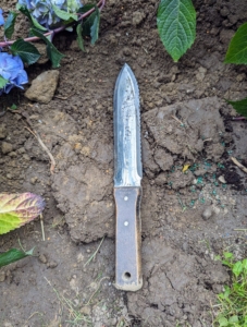 Josh uses a Japanese hori hori knife. A hori hori is a Japanese gardening tool with a sharp, serrated, multi-purpose steel blade. It's also known as a "soil knife" or "weeding knife" and is designed to be used as a trowel, knife, and saw.