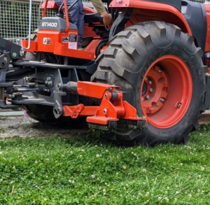 Here, the tractor’s stabilizing feet are extended to keep it well balanced and safe.