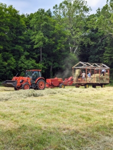 The same tractor is used to bale. Here it is pulling the baler and the hay wagon.