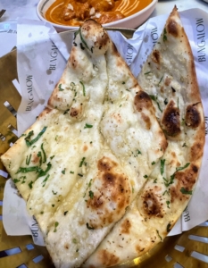 Everyone loves traditional naan - the leavened, oven-baked flatbread characterized by its light and slightly fluffy texture and golden-brown spots from baking. This garlic naan is a must-have.