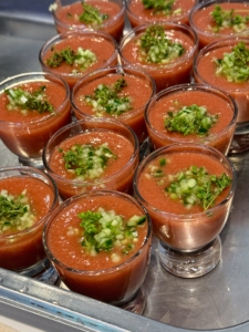 Glasses of flavorful gazpacho are handed out to start.