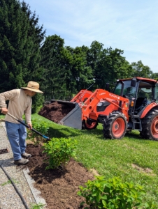 The entire perimeter is then dressed with mulch also made right here at the farm. It is delivered from my compost yard on our trusted our Kubota M4-071 tractor bucket and then spread in an even two to three inch layer.