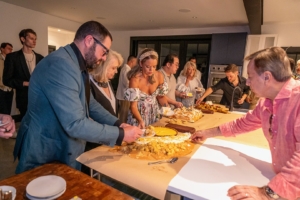 After a delicious feast, there's always room for dessert. Guests gathered around the dessert buffet for birthday cake, flourless chocolate cake, sweet zucchini bread, banana bread pudding, and cookies. (Photo by Charles Wills)