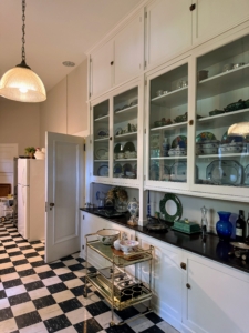 On the ground floor of Daheim, the kitchen wing is connected to the wood frame section of the house. Roomy wood and glass front cabinets were built all the way to the ceiling providing lots of storage space.