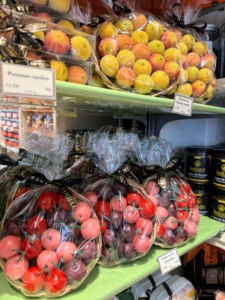 In this section, shelves are filled with pommes candies, tartelette de pommes candies, and cerises en pâte d'amandes.