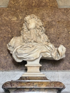 This is the Bernini bust of Louis XIV, a marble portrait by the Italian artist, Gian Lorenzo Bernini. It was created in 1665 during Bernini’s visit to Paris and has been called the “grandest piece of portraiture of the baroque age”. The bust is in the Salon de Diane in the King’s Grand Apartment.