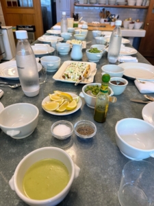 At Skylands, most of the meals are served casually in my kitchen at this long metal topped table. In the back of this room, I have what I call my "Great Wall of China" where I keep a large collection of all white dishes used for everyday dining.