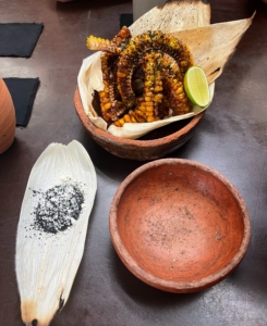 These are fried corn ribs made by slicing, seasoning, and cooking strips of corn and serving with a creamy, spicy sauce.