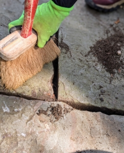 Oscar then brushes all the debris out of the way. There's no set schedule for repointing pavers, but one should consider maintenance work if pavers are cracked, mortar or stone dust is crumbling, or if weeds begin growing between the slabs.