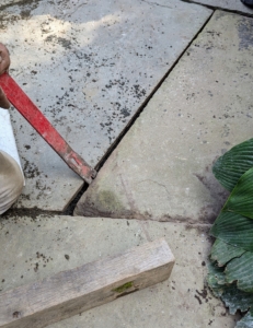 Here, the same crowbar is used to make minor adjustments to ensure spacing between the pavers is even.