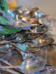 There are actually several ways to clean silver. A frequently recommended, nontoxic method is to fill an aluminum pan with hot water, add salt and baking soda, stir until it is all dissolved, and then soak the pieces until a chemical reaction occurs that removes the tarnish. This technique is faster than hand cleaning, but may cause pitting and remove the desirable antique patina. Silver cleaning cloths made especially for removing tarnish from precious metals are also available, but experts recommend using a good-quality, non-abrasive commercial silver polish.