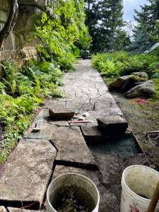 After working on the walls, the team moves on to check the pavers. They checked all the footpaths and adjusted any stone that may have shifted over time because of inclement weather and growing roots underneath.