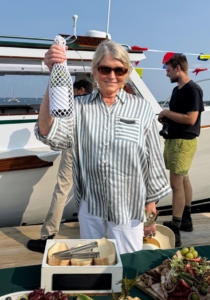 Here I am with the bottle of champagne before the breaking ceremony, when the bottle is broken against the boat's bow.