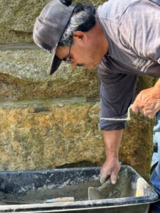 Here, Alfonso carefully mixes the new mortar. The right mortar mix is crucial for a long-lasting, sturdy structure.