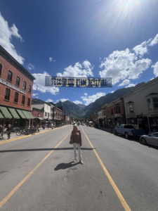 Here I am on Main Street in Telluride. The town’s historic district includes landmarks such as the Sheridan Opera House, a performing-arts venue originally built in 1913, and the Telluride Historical Museum, which showcases local history in a converted hospital built in 1896. One can see the mountains behind me. This annual festival attracts about 5000 visitors a year.