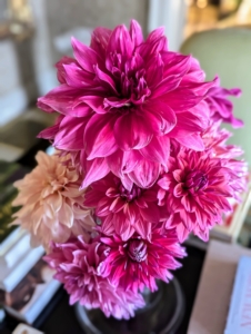 I like to display seasonal flowers or plants throughout my home whenever I entertain. This is an all dahlia arrangement in bold shades of pink.