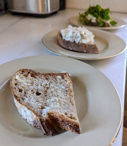 To prepare my sandwiches, I cut thick slices of bread, buttered each one lightly, and then dressed with chicken salad.