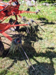 Here are tines, or moving forks, pointing downward and ready to aerate or “wuffle” the hay and speed up the drying process even more. The tedder moves up and down the field taking all the greener hay from the bottom and turning it over to dry.