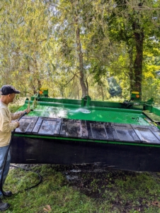 This is our mower-conditioner. A hay mower conditioner cuts, crimps and crushes the hay to promote faster and more even drying. My outdoor grounds crew foreman, Chhiring Sherpa, thoroughly power washes the hood and top of the mower.